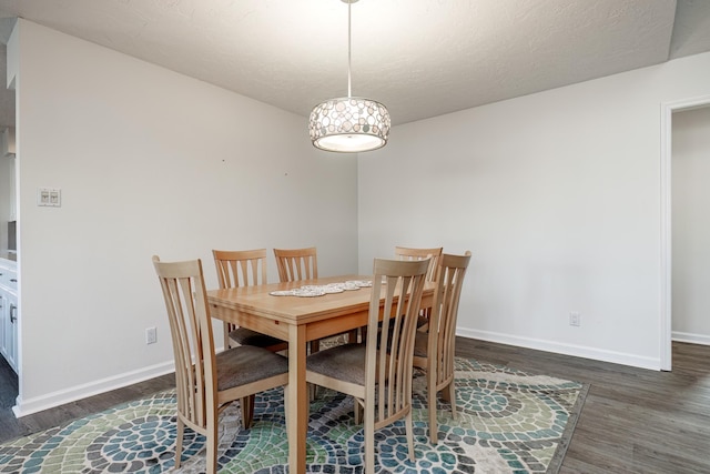 dining space with dark wood-type flooring