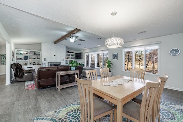 dining space featuring hardwood / wood-style floors, a textured ceiling, and a wealth of natural light