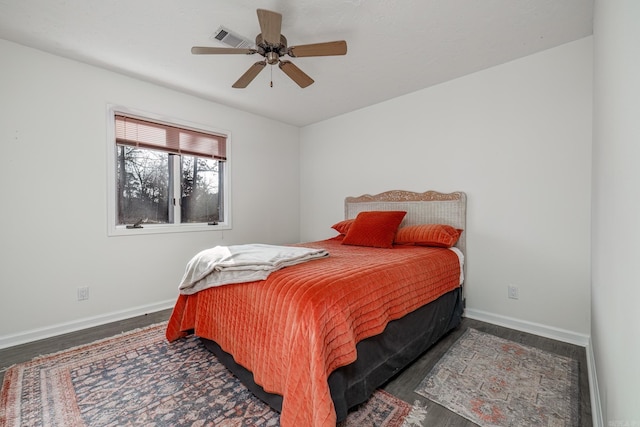 bedroom with ceiling fan and dark hardwood / wood-style floors