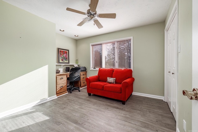 home office with hardwood / wood-style flooring and ceiling fan