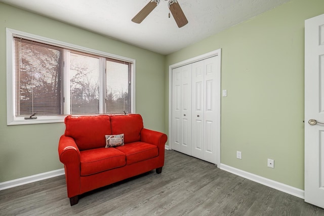 sitting room featuring hardwood / wood-style floors and ceiling fan