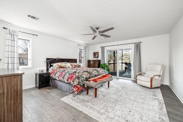 bedroom with ceiling fan, hardwood / wood-style floors, and access to outside