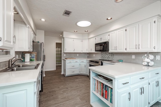 kitchen featuring white cabinetry, sink, dark wood-type flooring, and tasteful backsplash