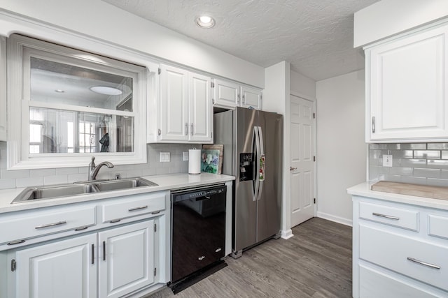 kitchen with sink, dishwasher, stainless steel refrigerator with ice dispenser, a textured ceiling, and white cabinets