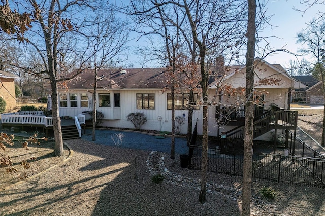 back of house featuring a wooden deck