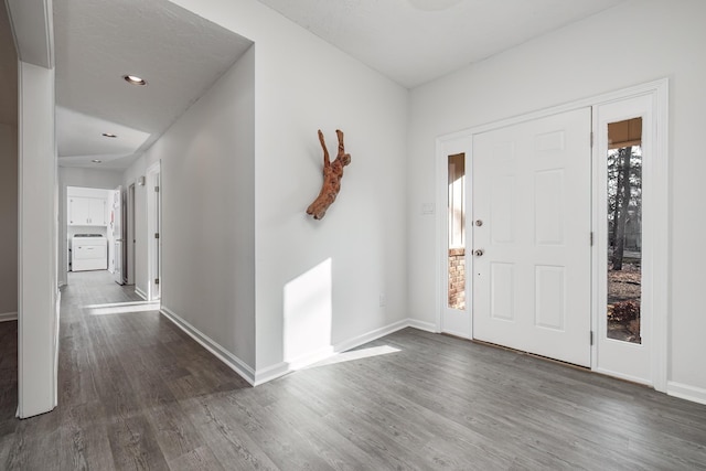 foyer featuring washer / dryer and dark hardwood / wood-style floors