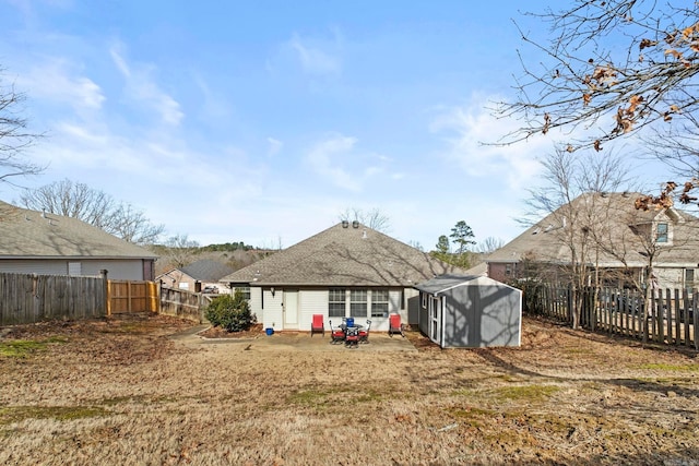 back of property with a shed and a lawn