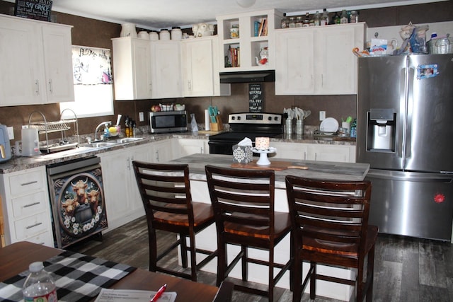 kitchen with dark hardwood / wood-style floors, white cabinetry, sink, light stone counters, and stainless steel appliances