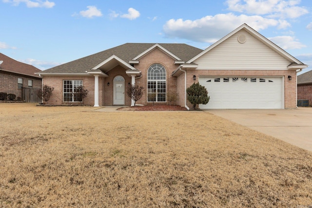 ranch-style home with a garage and a front yard