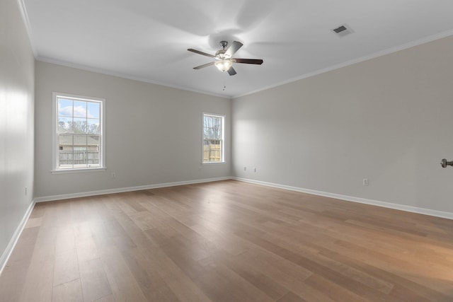 empty room featuring ornamental molding, ceiling fan, and light hardwood / wood-style flooring