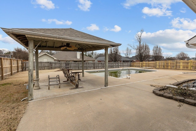 view of swimming pool featuring ceiling fan and a patio