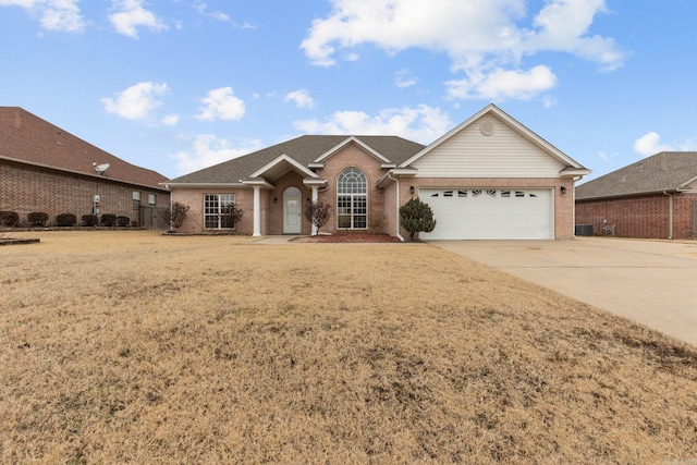 ranch-style house with a garage and a front lawn