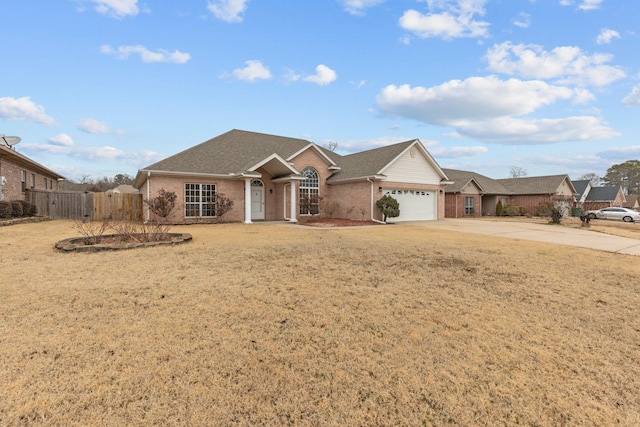 single story home with a garage and a front lawn