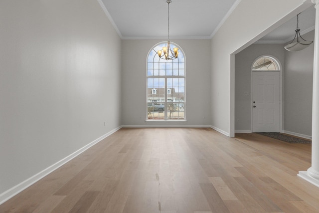 interior space with crown molding, light wood-type flooring, an inviting chandelier, and a wealth of natural light