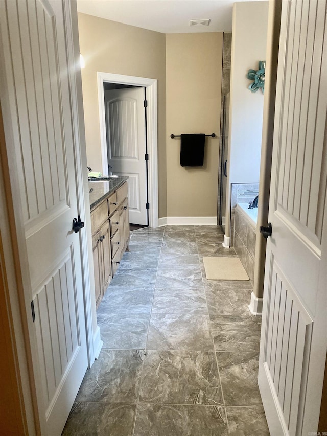 bathroom with vanity and a bathing tub