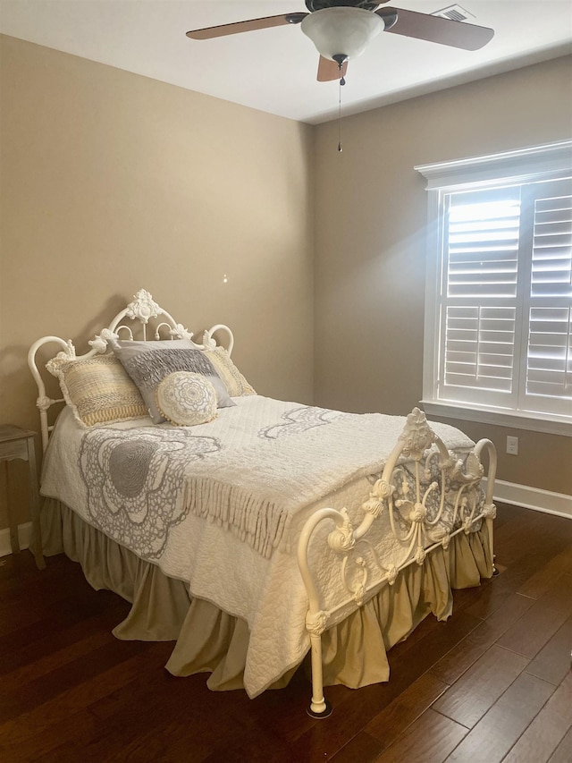 bedroom featuring dark hardwood / wood-style flooring and ceiling fan