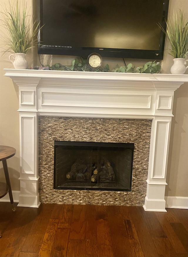 interior details with hardwood / wood-style flooring and a fireplace