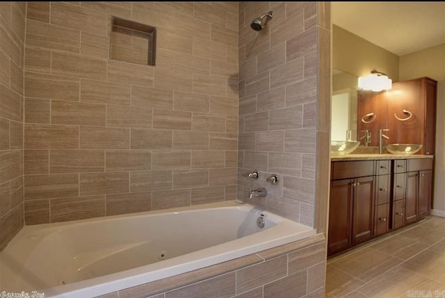 bathroom with vanity, tiled shower / bath combo, and tile patterned flooring