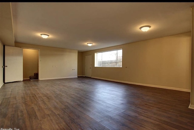 unfurnished room featuring dark wood-type flooring