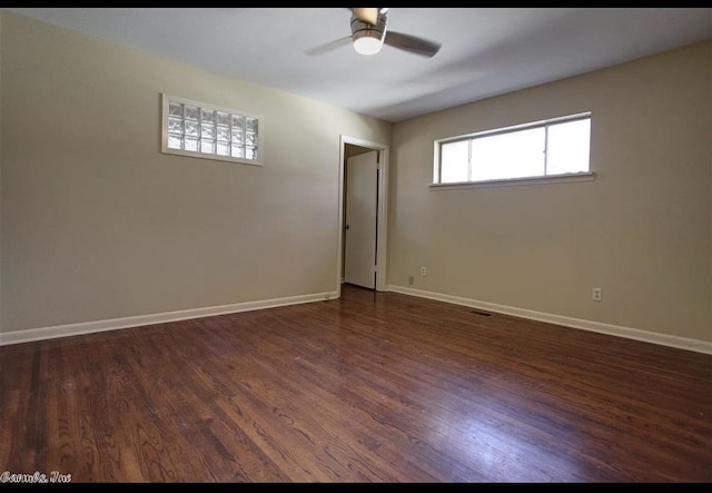 empty room with dark wood-type flooring and ceiling fan