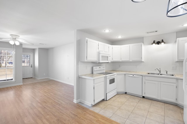 kitchen with sink, white cabinets, light tile patterned floors, ceiling fan, and white appliances