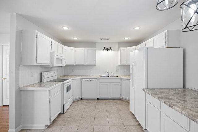 kitchen featuring light tile patterned flooring, sink, white cabinetry, tasteful backsplash, and white appliances