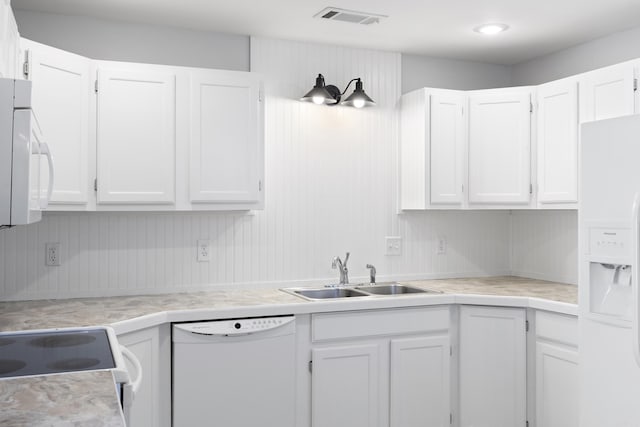 kitchen with white cabinetry, white appliances, and sink