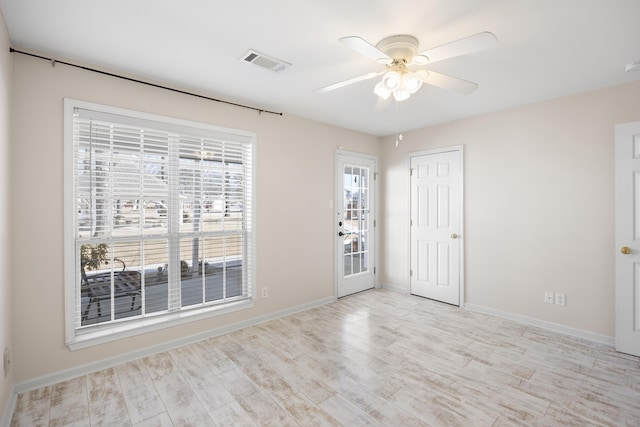 spare room featuring light wood-type flooring and ceiling fan