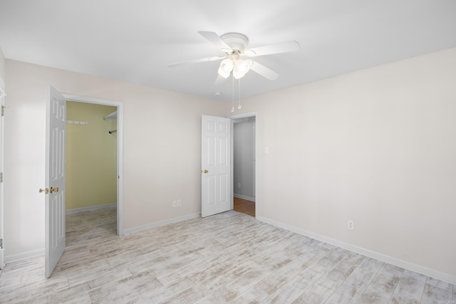 empty room featuring ceiling fan and light wood-type flooring