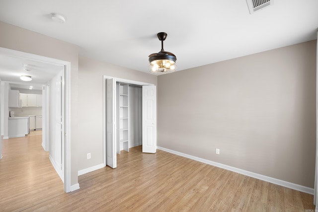 unfurnished bedroom featuring a closet and light hardwood / wood-style flooring