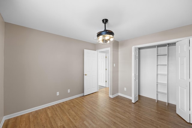 unfurnished bedroom featuring hardwood / wood-style flooring and a closet