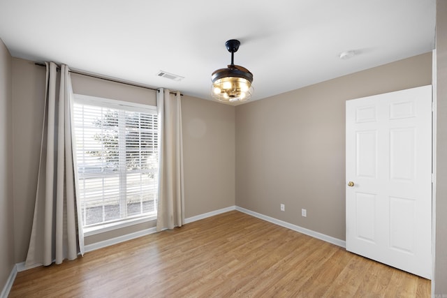 spare room featuring plenty of natural light and light wood-type flooring