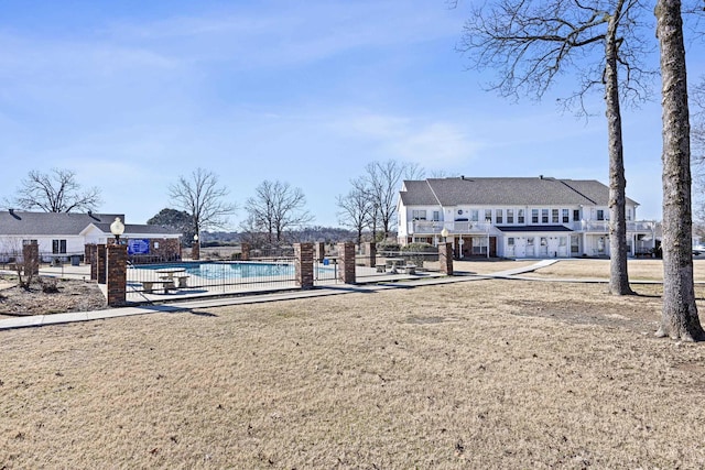 surrounding community with a pool and a lawn