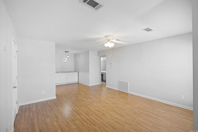 spare room featuring light wood-type flooring and ceiling fan