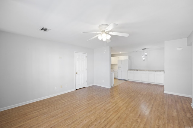 unfurnished living room with ceiling fan and light wood-type flooring