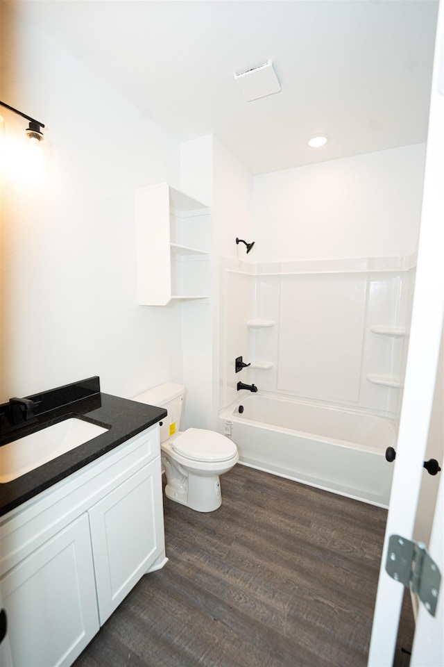 full bathroom featuring vanity, hardwood / wood-style floors,  shower combination, and toilet