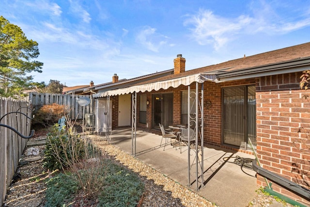 rear view of property featuring a patio area