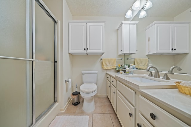 bathroom featuring tile patterned flooring, vanity, an enclosed shower, a textured ceiling, and toilet