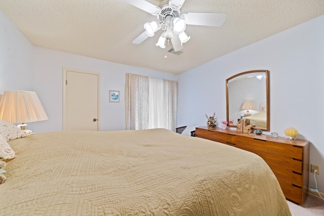 bedroom with ceiling fan and a textured ceiling