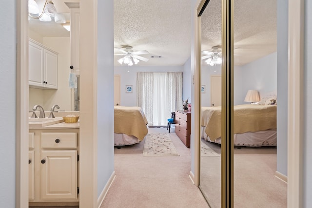 bathroom featuring vanity, a textured ceiling, and ceiling fan