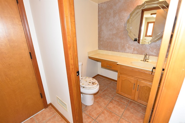 bathroom featuring vanity, tile patterned floors, and toilet