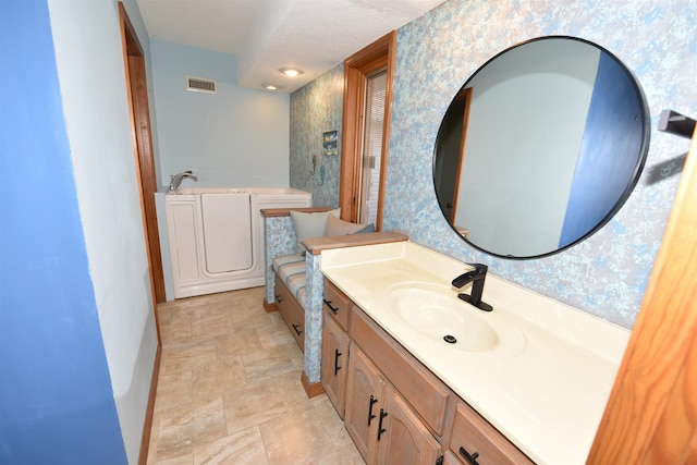 bathroom with vanity and a textured ceiling