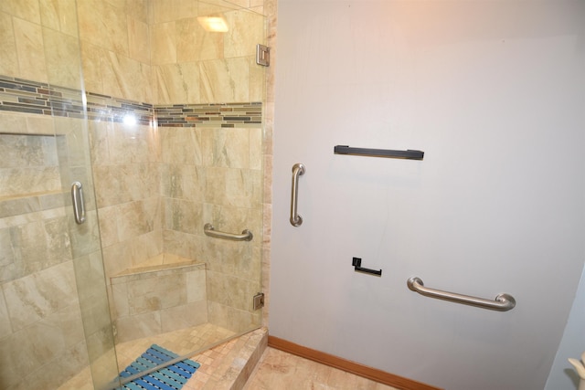 bathroom featuring a shower with shower door