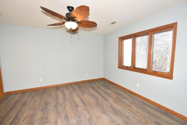 spare room featuring dark hardwood / wood-style floors and ceiling fan