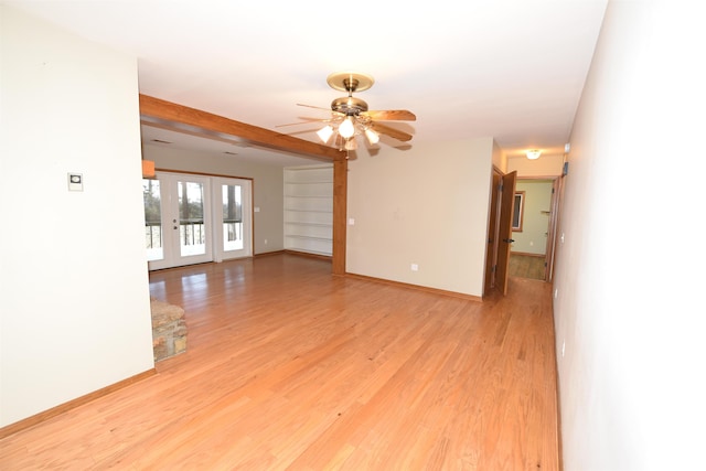 unfurnished room featuring beamed ceiling, light hardwood / wood-style flooring, french doors, and ceiling fan