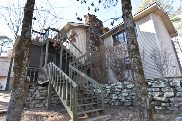 view of home's exterior with a sunroom