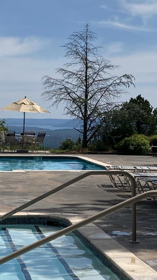 view of swimming pool featuring a mountain view