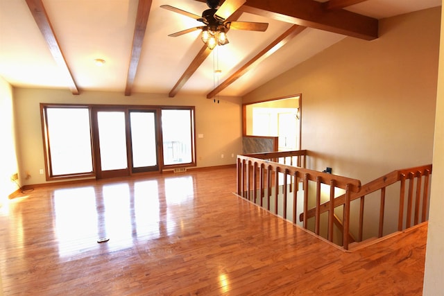 interior space with lofted ceiling with beams, light hardwood / wood-style floors, and ceiling fan