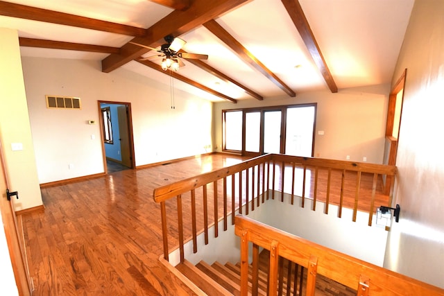 interior space with vaulted ceiling with beams, hardwood / wood-style floors, and ceiling fan