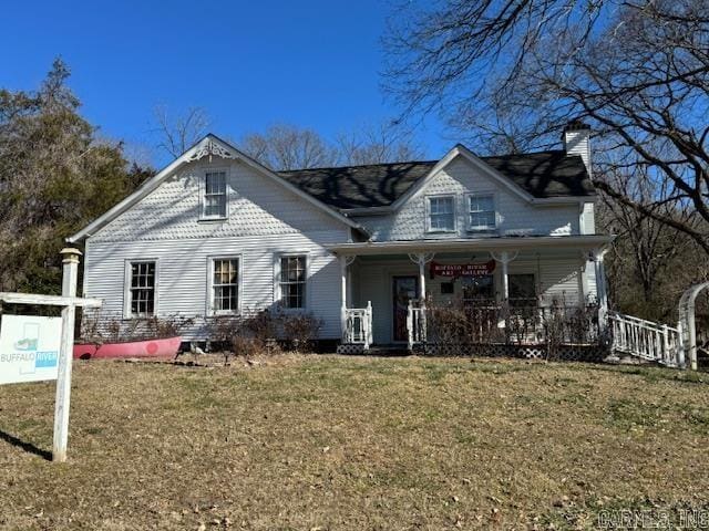 view of front of home with a front yard and covered porch